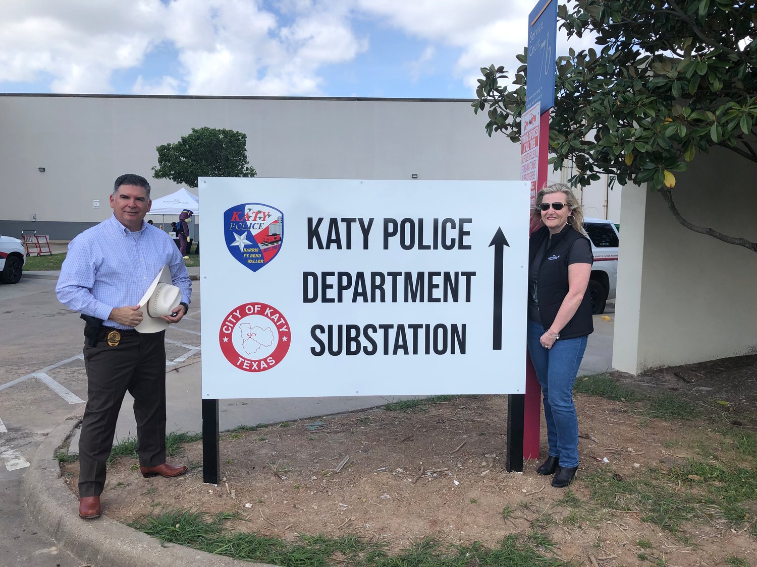 Noe Diaz, police chief, and Heidi MacMillan, Katy Mills general manager, pose at the new Katy Police substation sign.
